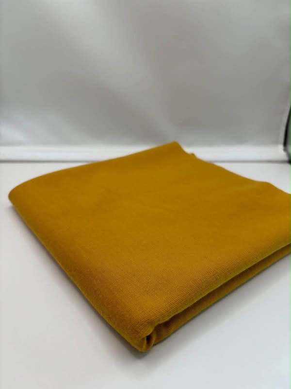 Mustard ponte roma fabric folded