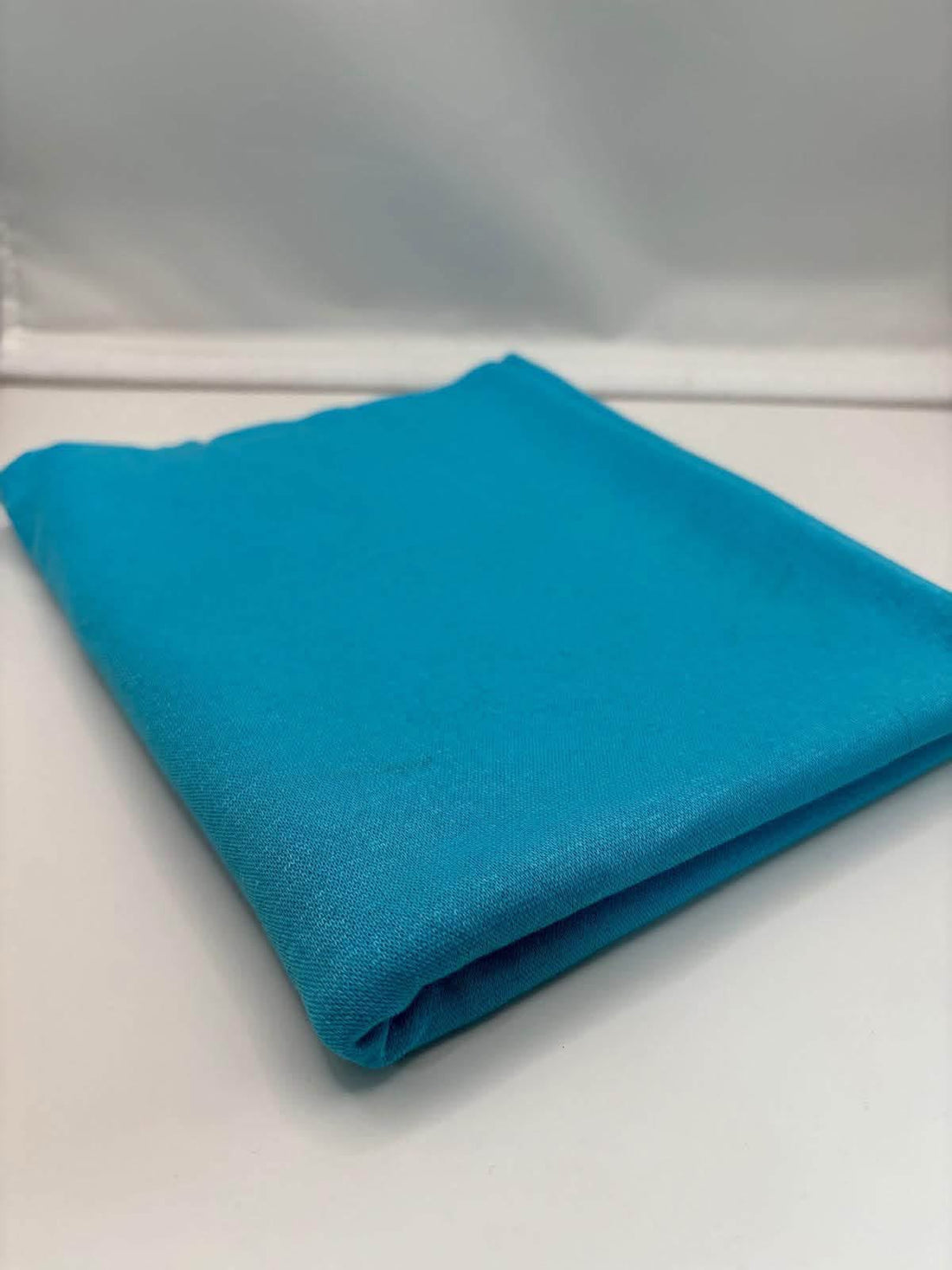 Turquoise ponte roma fabric folded