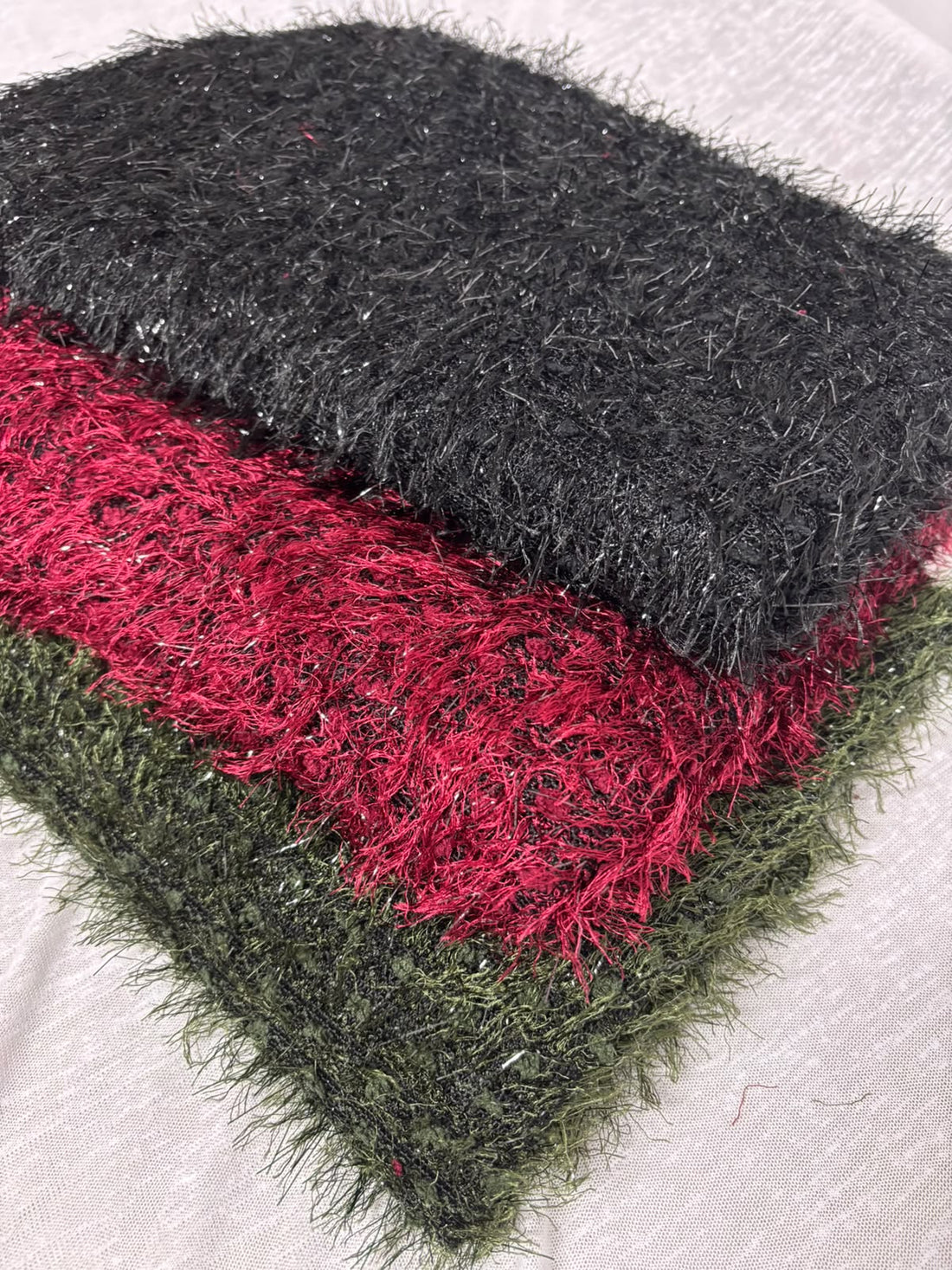 Sparkle eyelash knit fabric in black, raspberry and olive