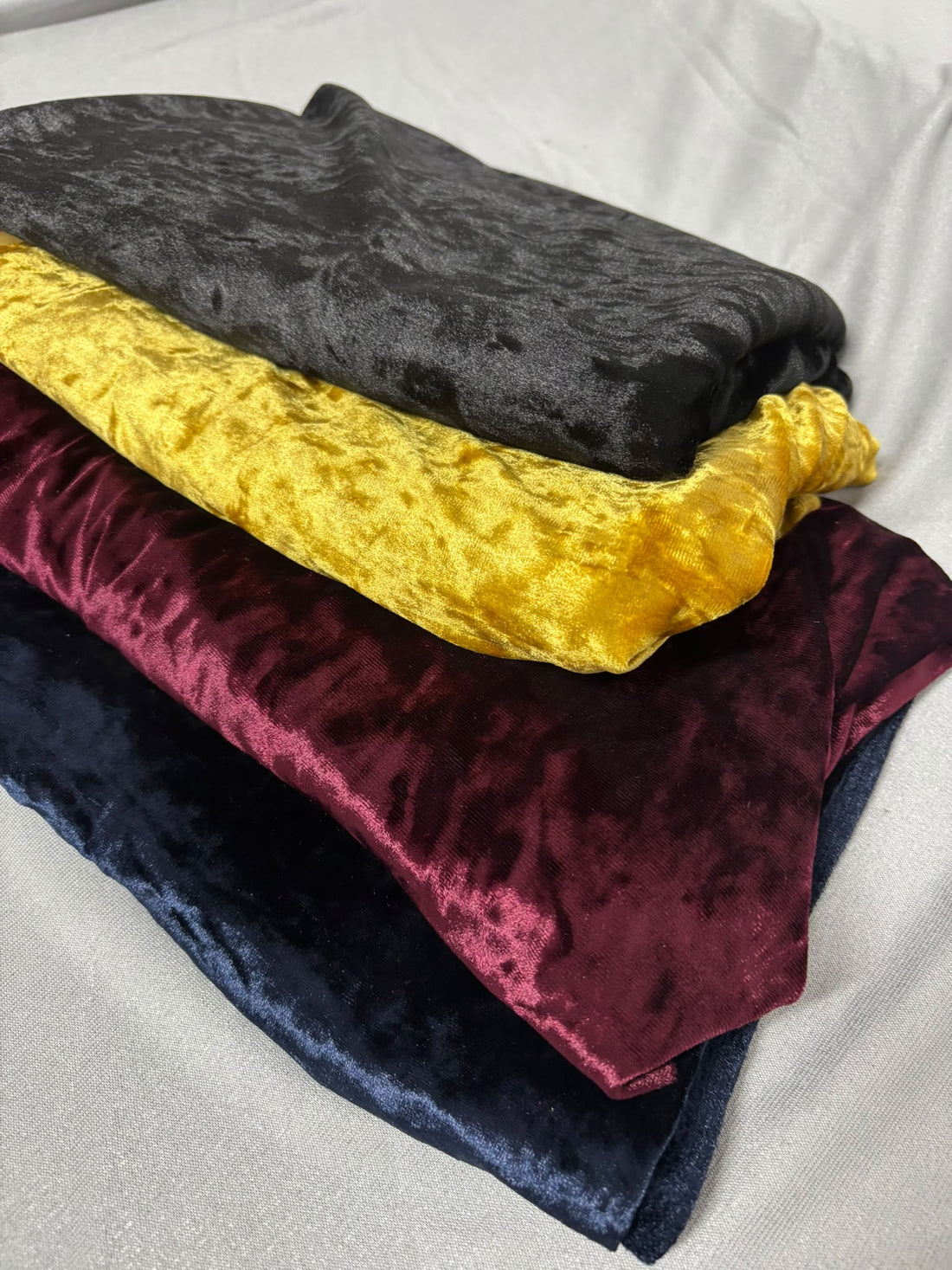 Stretch crushed velvet fabric in black, mustard gold, wine and navy